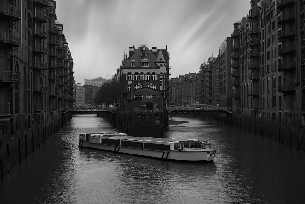 a small boat in a body of water with a city in the background