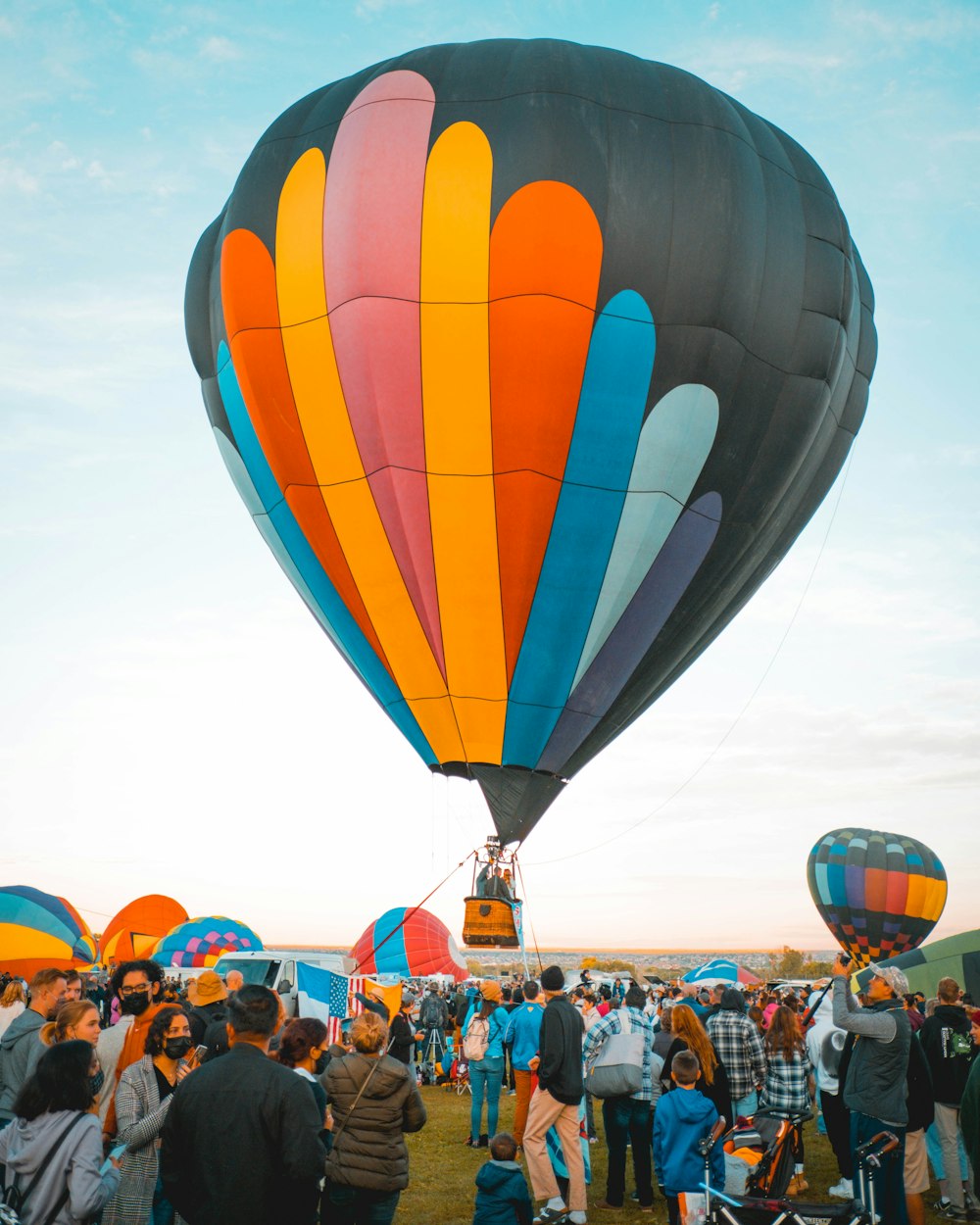 a group of people standing around a hot air balloon