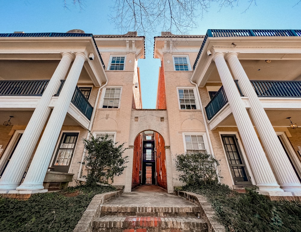 a building with columns and a red door