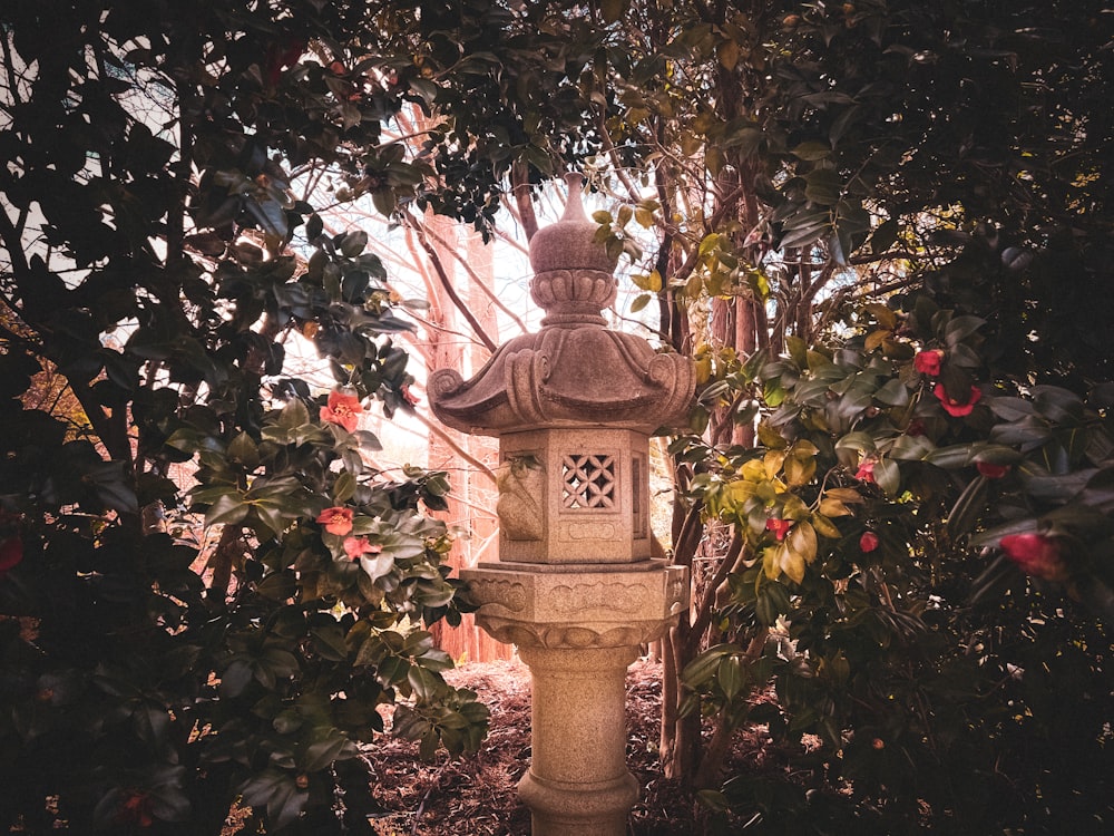 a stone lantern in the middle of a garden