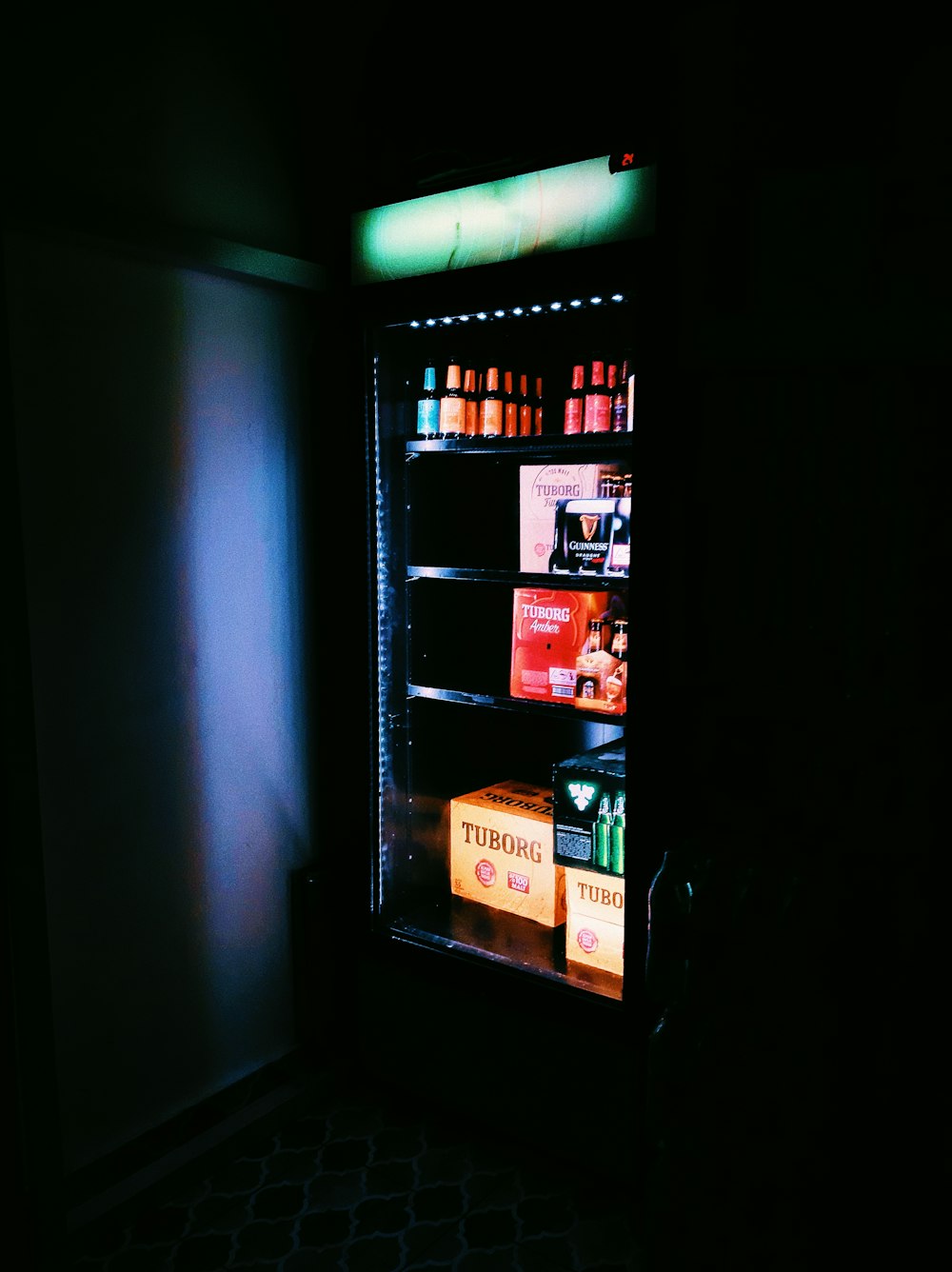 a vending machine is lit up in the dark