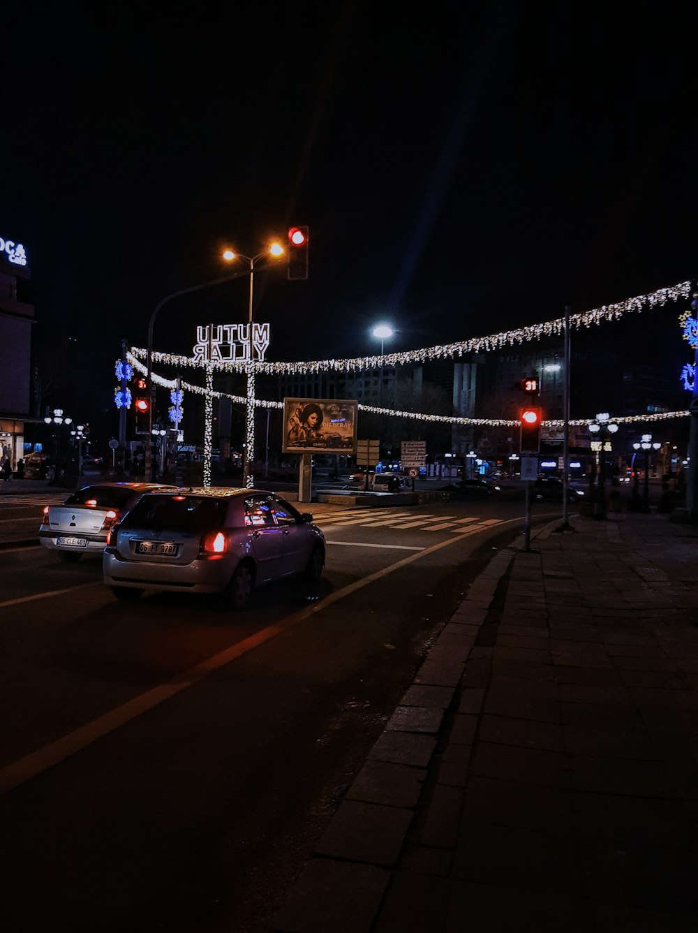 a car driving down a city street at night