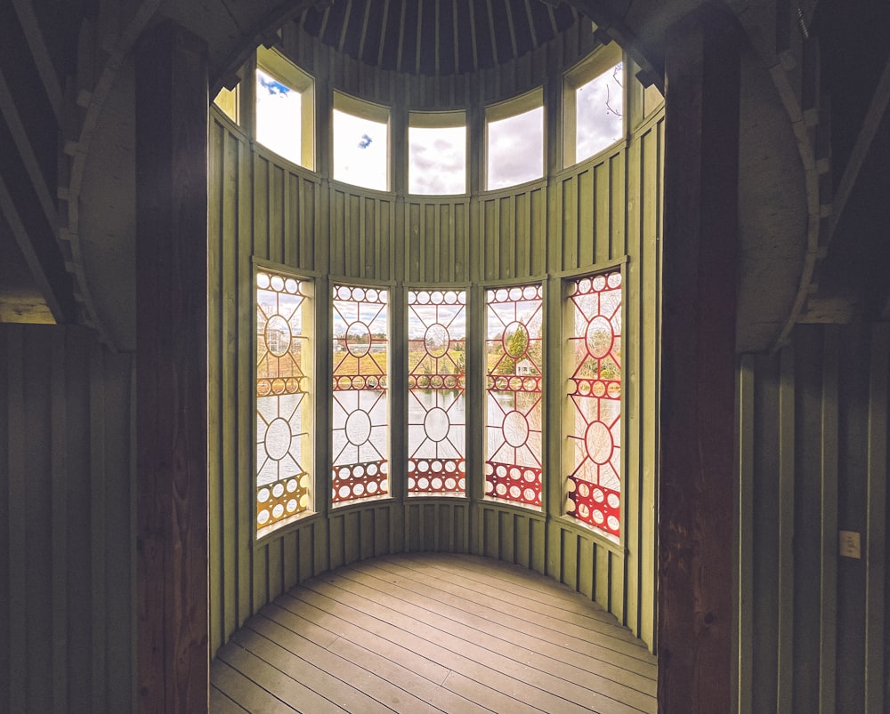 a circular room with three stained glass windows