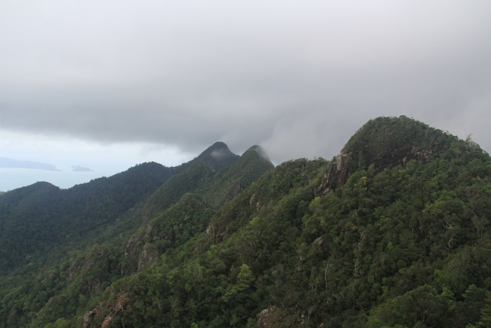 a view of the top of a mountain with a cloudy sky