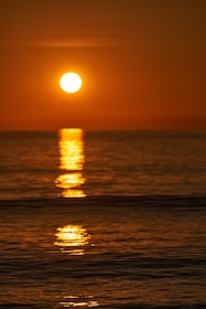 A vibrant sunset casting colors over the ocean horizon.