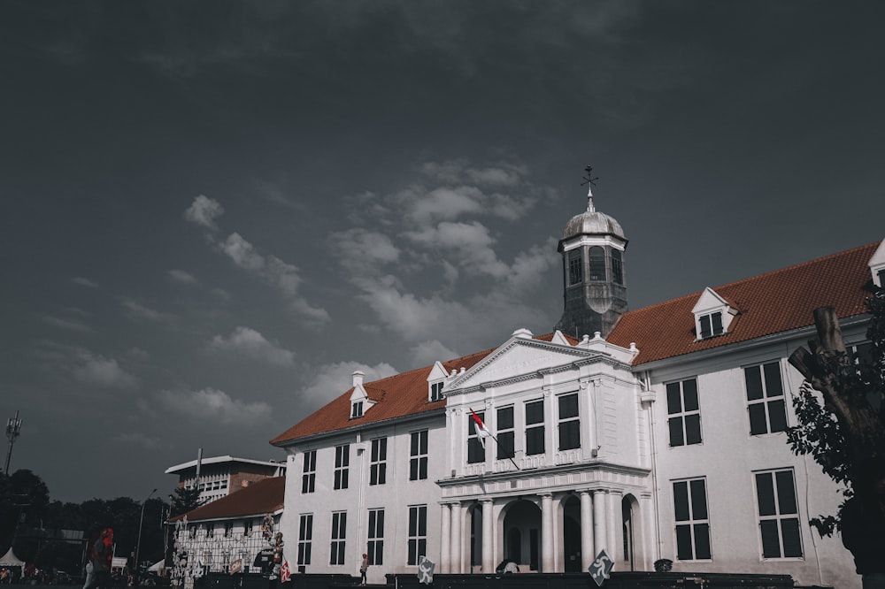 a large white building with a red roof