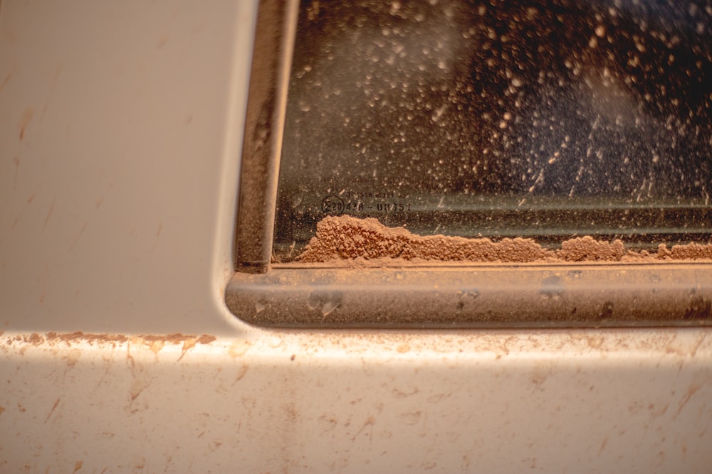 a close up of a window with dirt on it