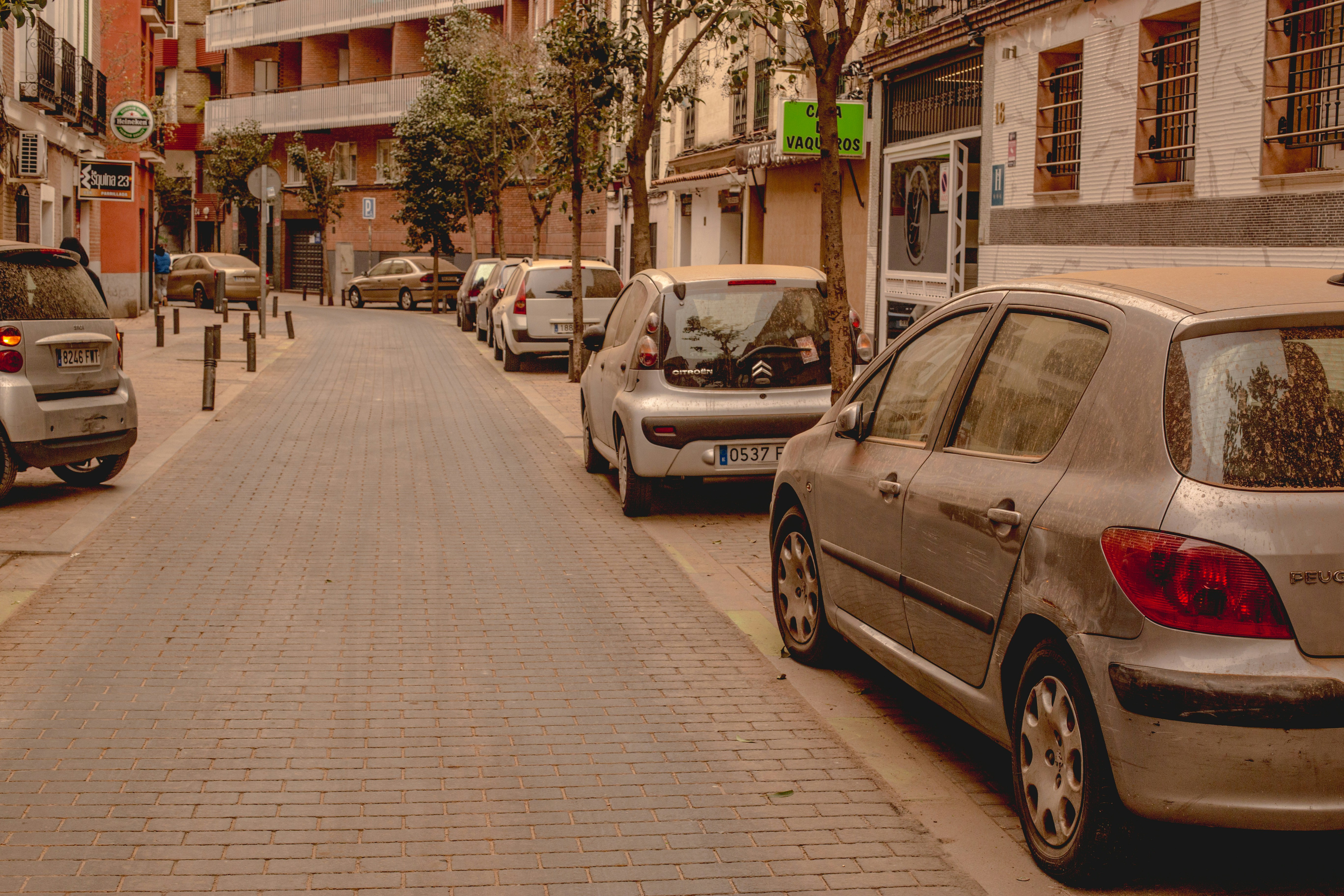 Small electric car driving through busy city traffic in India