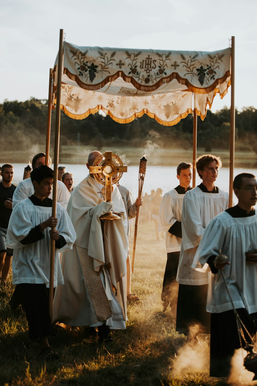 a group of people standing around a cross