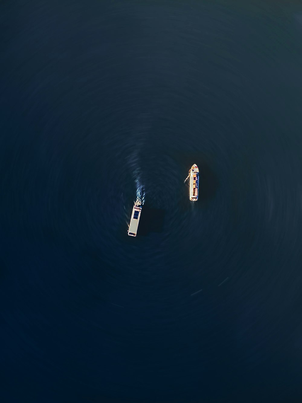 a couple of boats floating on top of a body of water