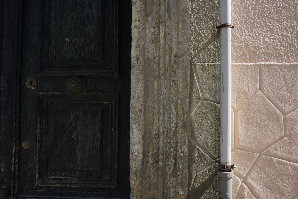 a close up of a street light next to a door