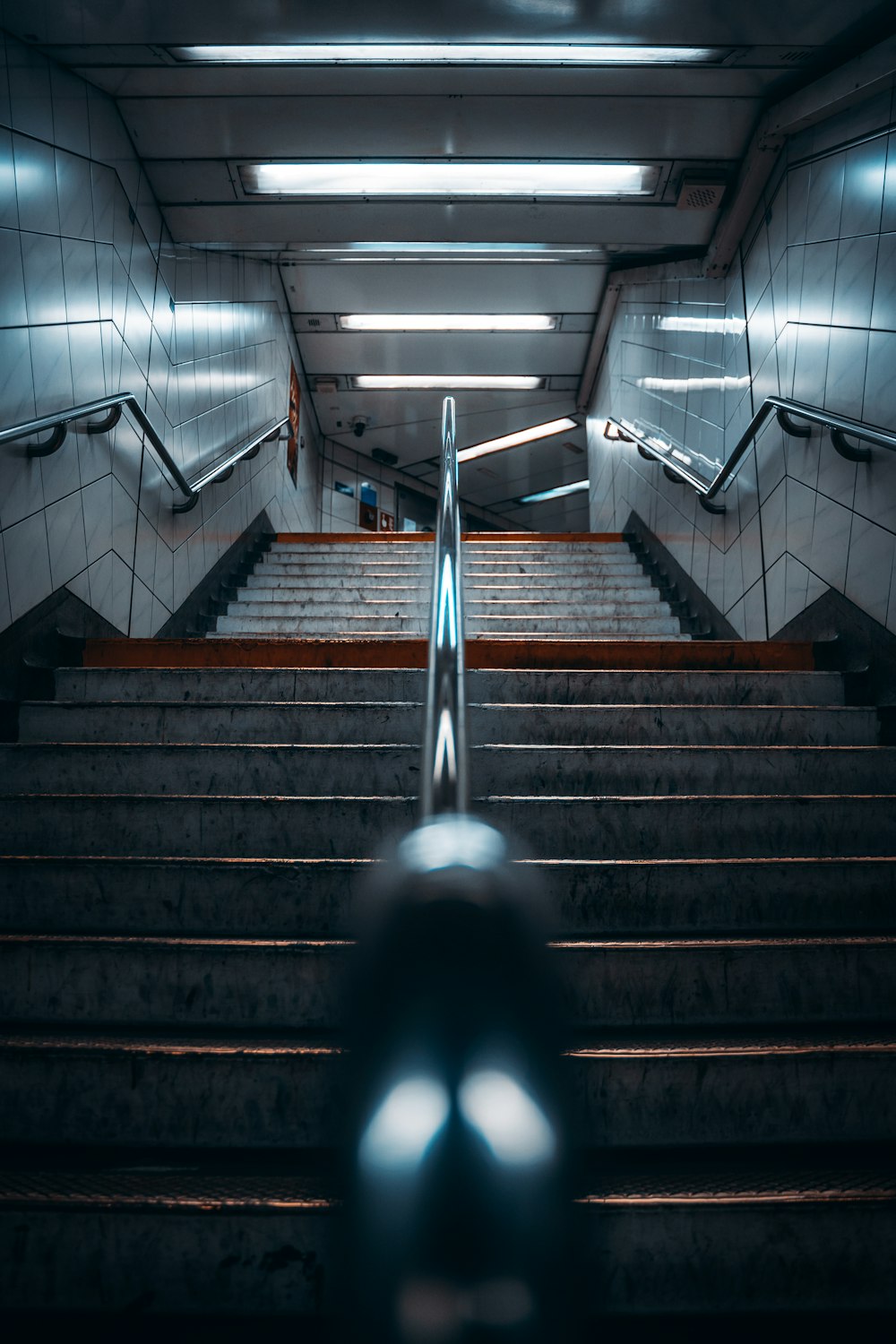 an escalator in a subway station with stairs