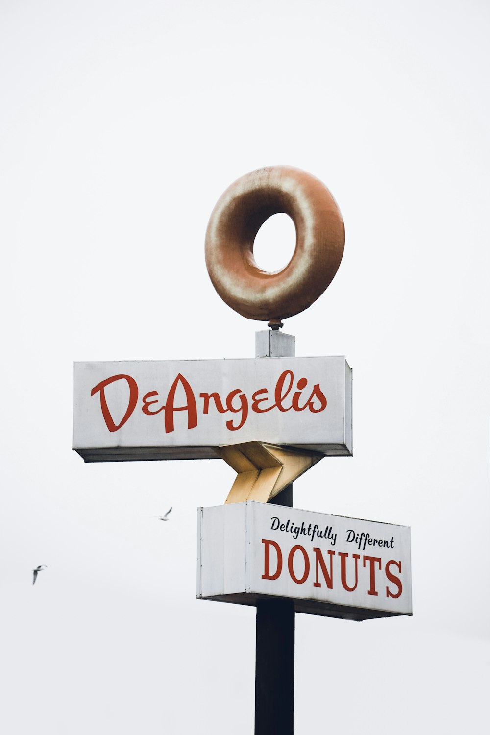 a doughnut sign with a donut on top of it