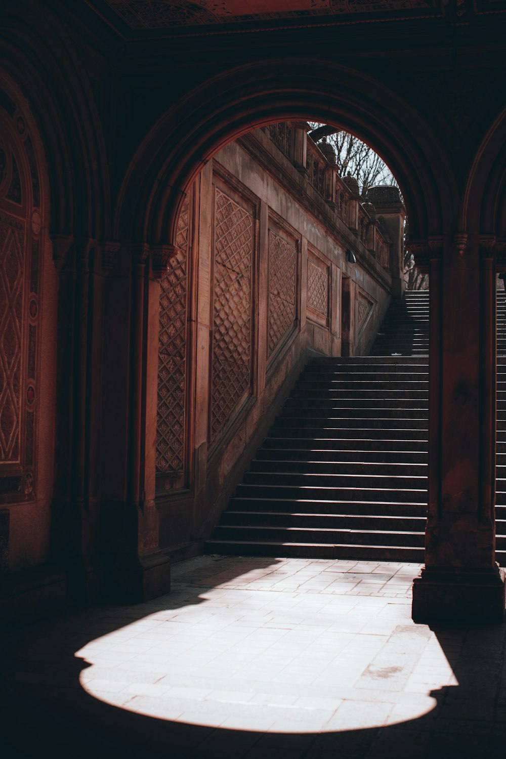 a stone staircase with arches leading up to it