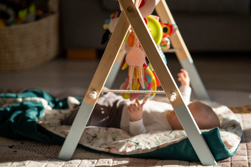 a baby is playing with a toy on the floor