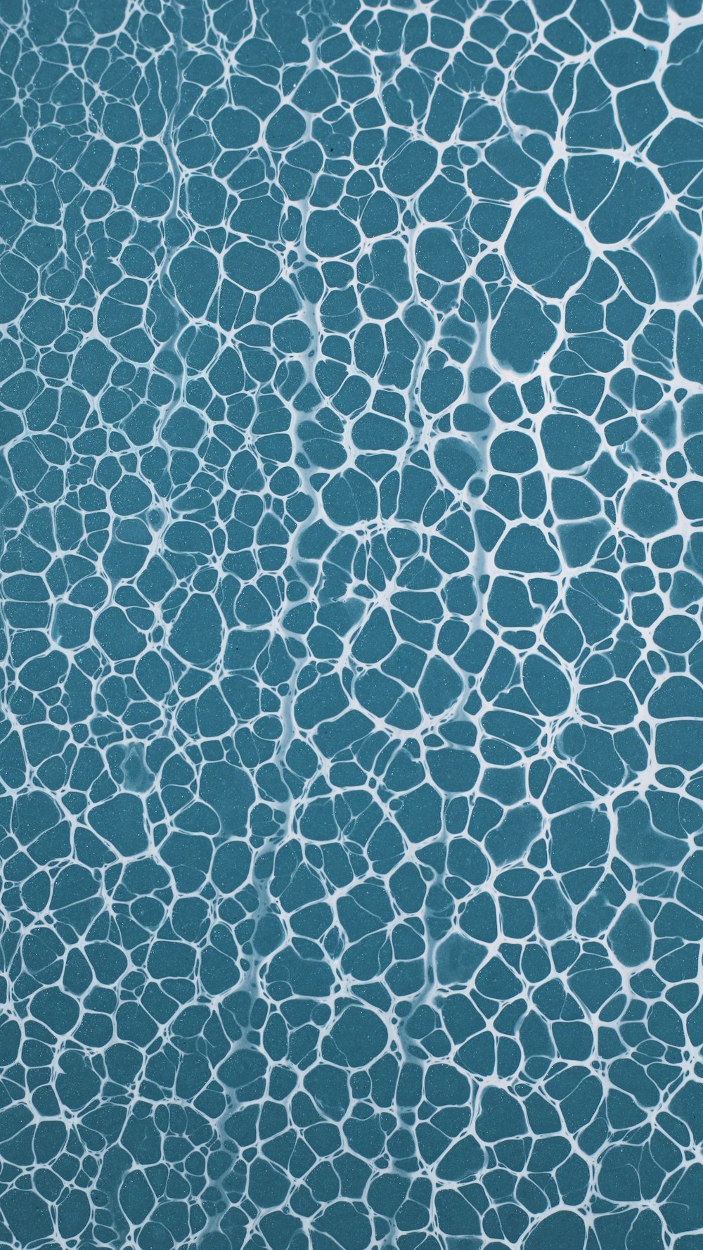 a blue water surface with white lines on it