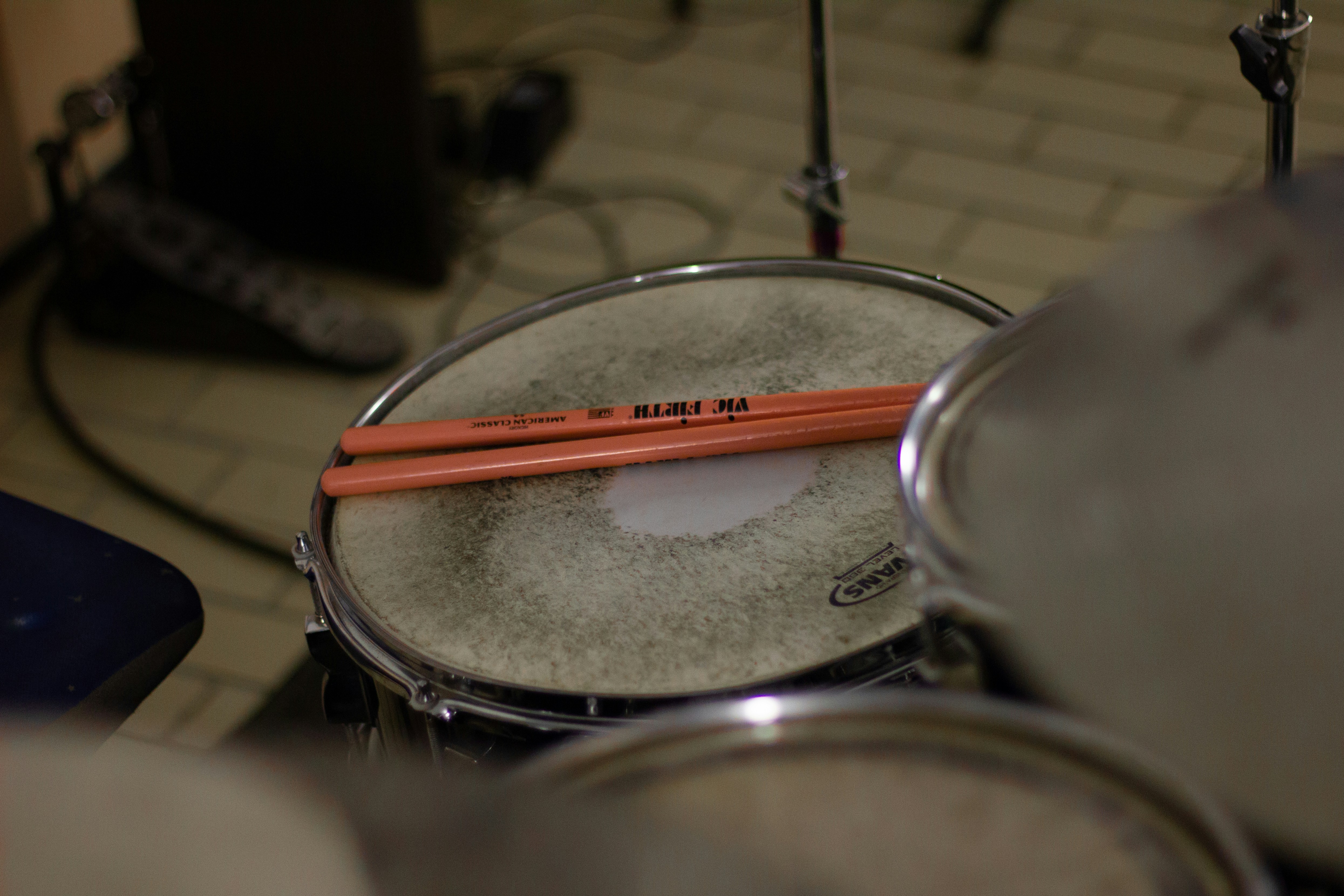 a close up of a drum set with a pair of sticks