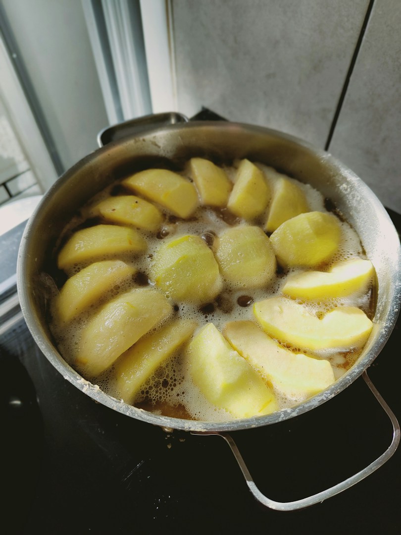 Slice of tarte tatin, the French caramelized apple tart, served on a rustic table