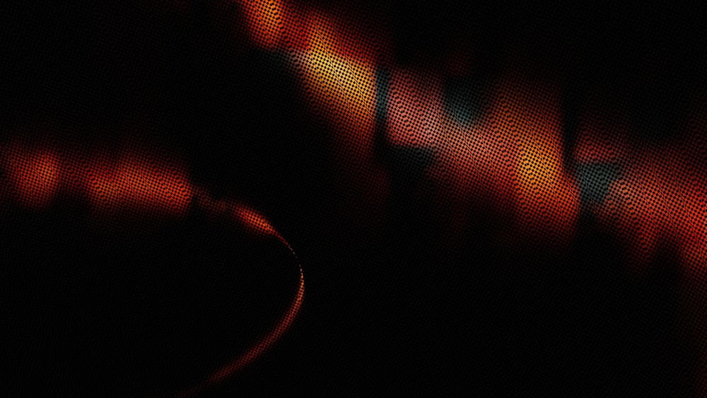 a blurry photo of a black background with red and yellow lights