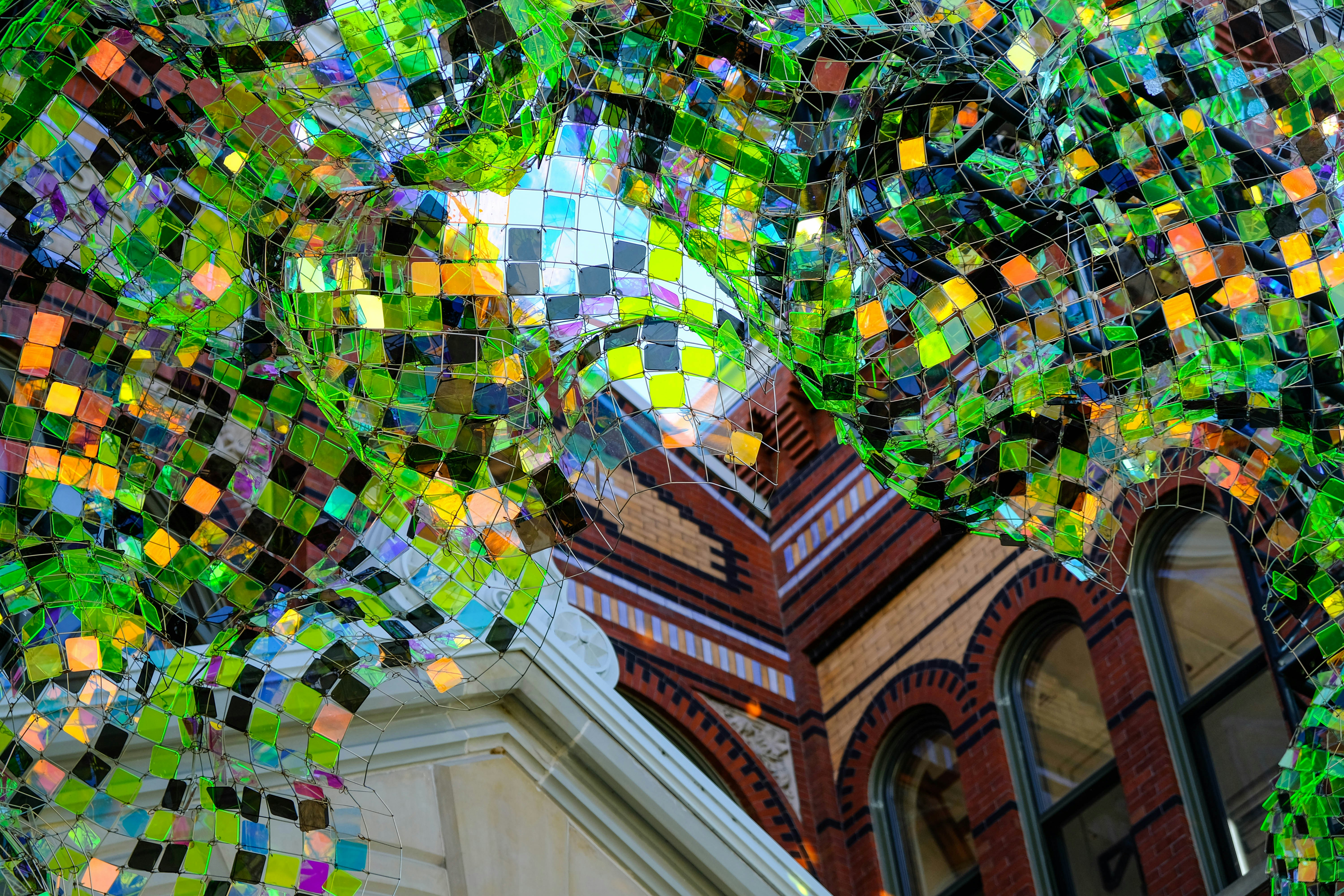 a building with a clock tower covered in multicolored tiles