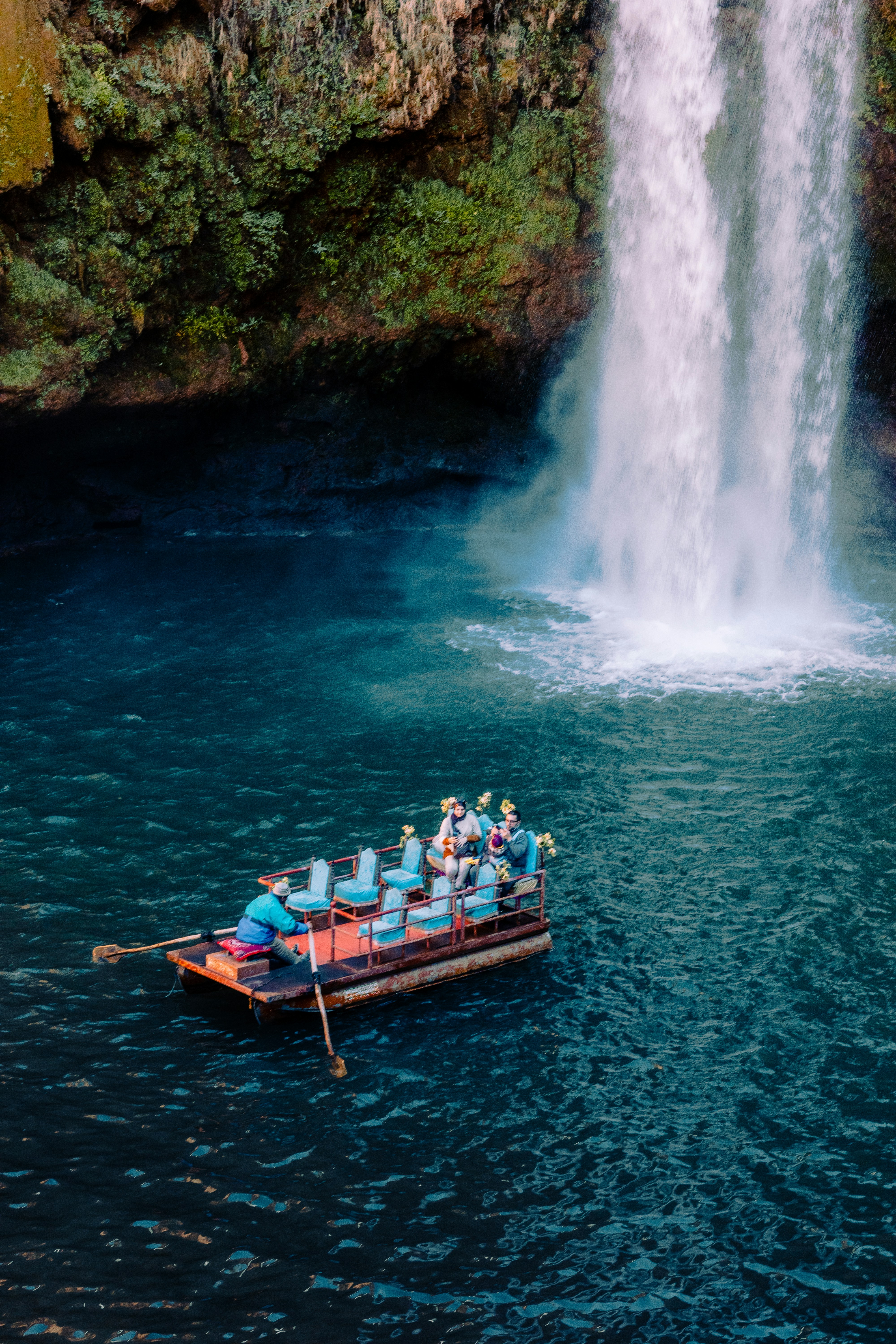 A boat filled with people in front of a waterfall photo – Free Nature ...