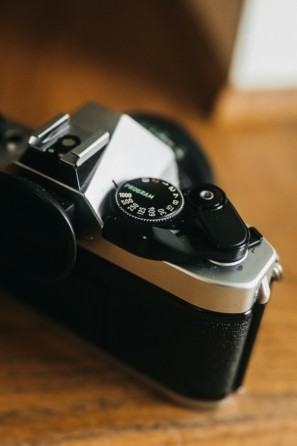 a close up of a camera on a wooden table