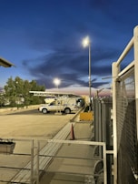 Security guard patrolling a commercial property at dusk.