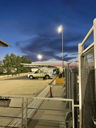 Industrial parking lot monitored by multiple intelligent cameras at dusk
