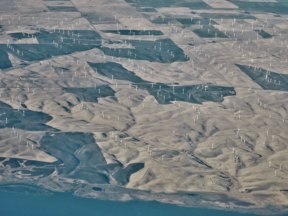 an aerial view of a mountain range and a body of water