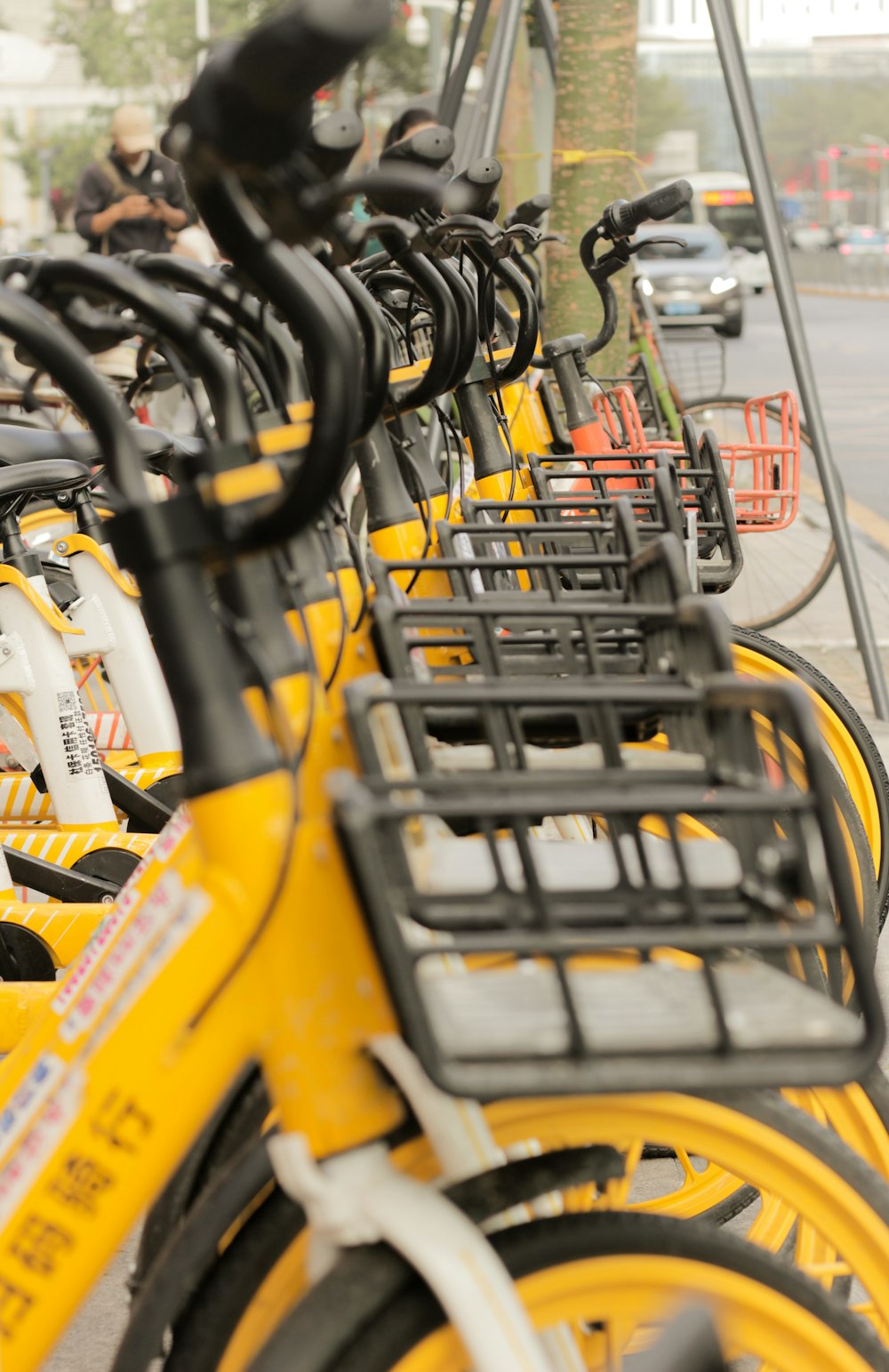 a row of yellow bicycles parked next to each other