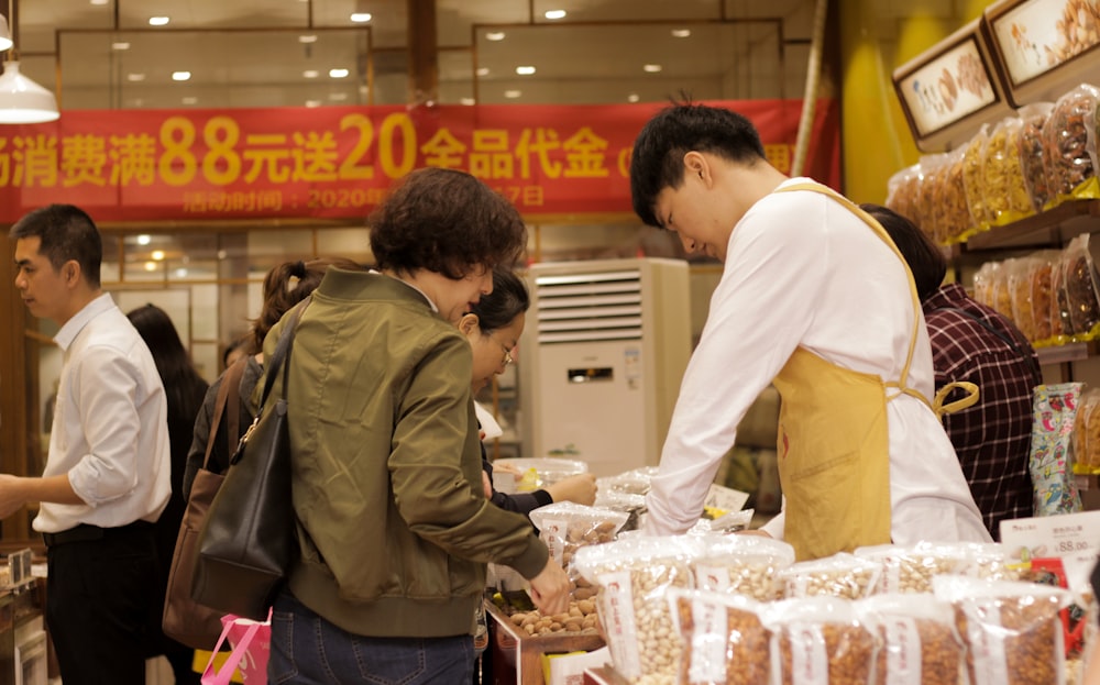 a group of people standing around a store