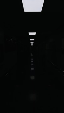 a long dark hallway with a skylight above it