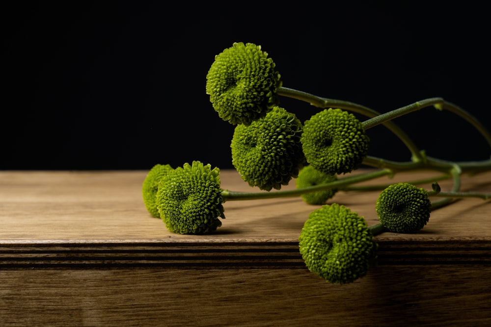 a bunch of broccoli sitting on top of a wooden table