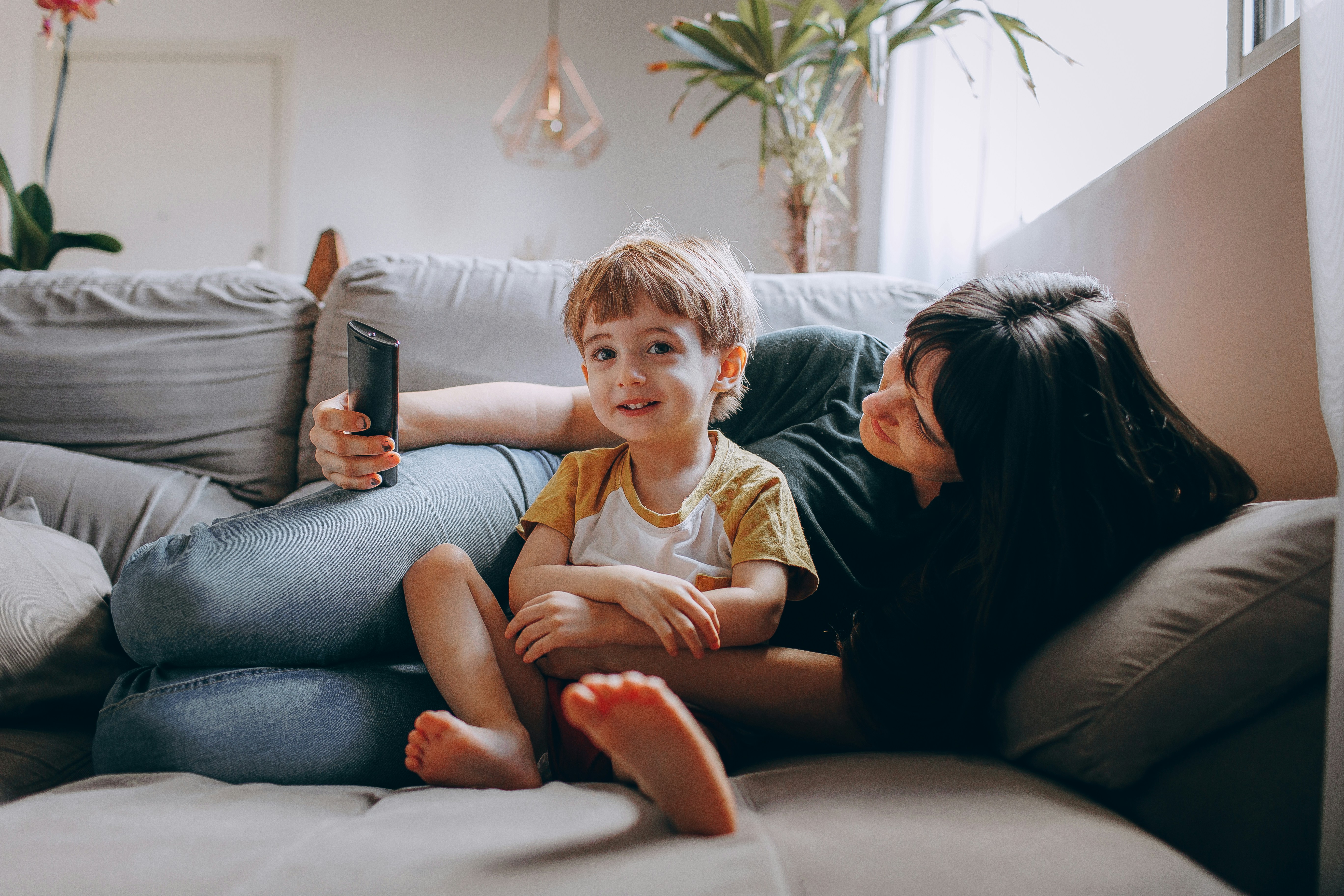 Parent and child sitting together calmly on a sofa - effective communication for parents