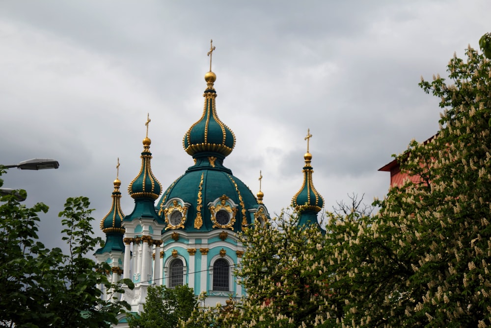 a blue and white building with gold domes