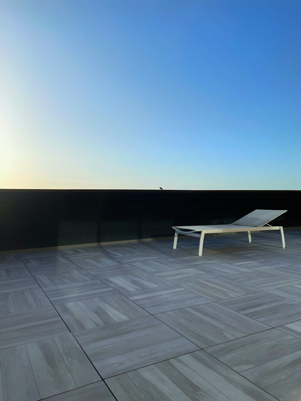 a white lounge chair sitting on top of a wooden floor