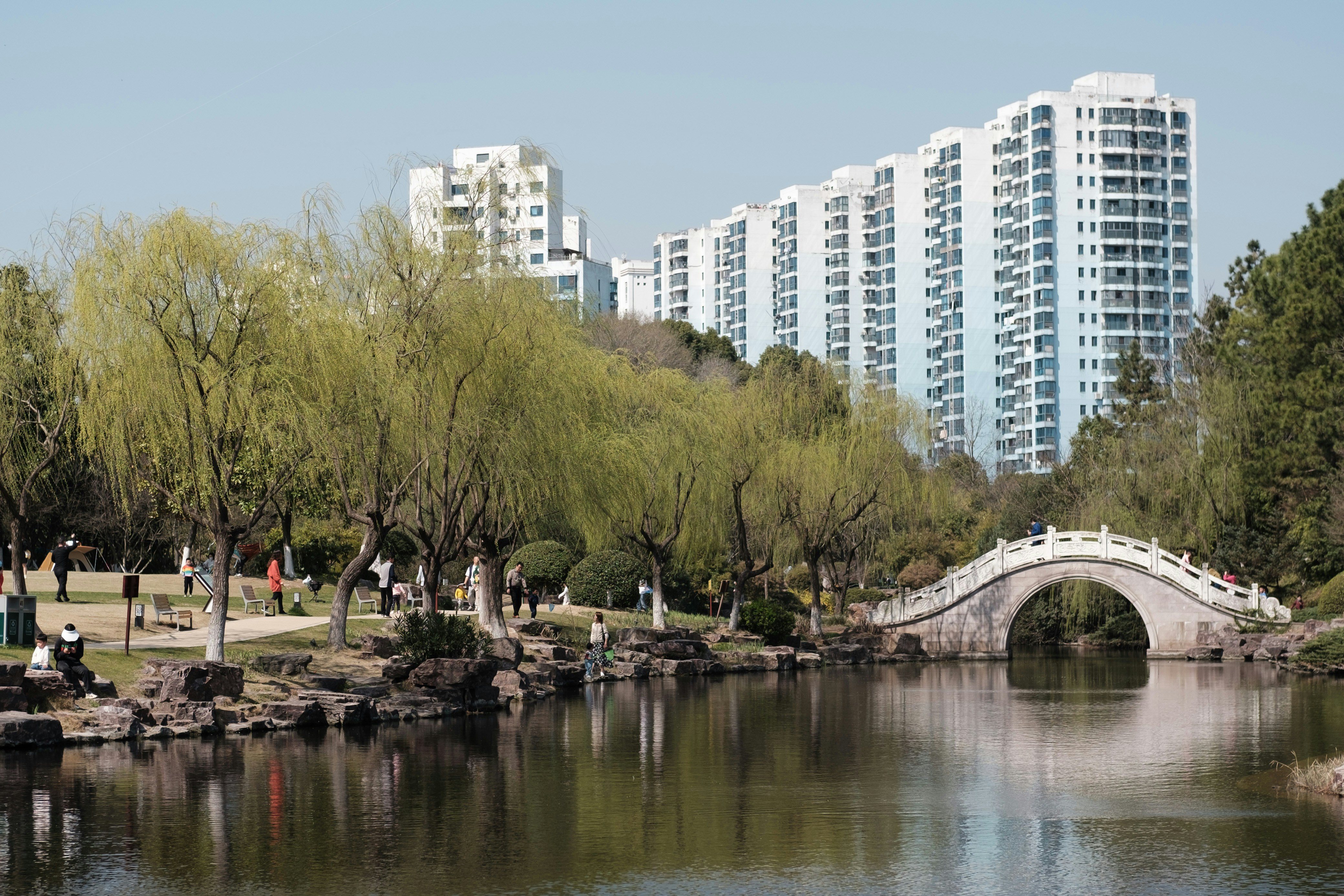 a bridge over a body of water near tall buildings