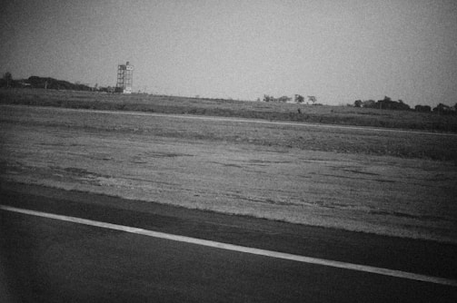 Elegant aerial black-and-white photograph showing a cluster of aviation estates with runways and hangars.