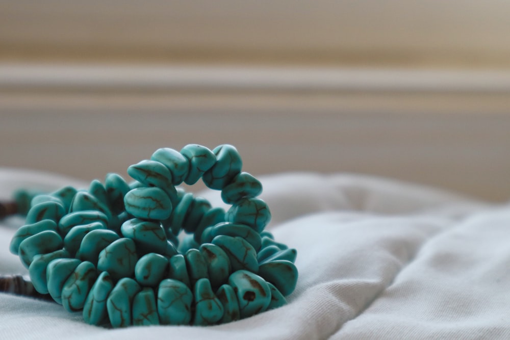 a close up of a bunch of beads on a bed