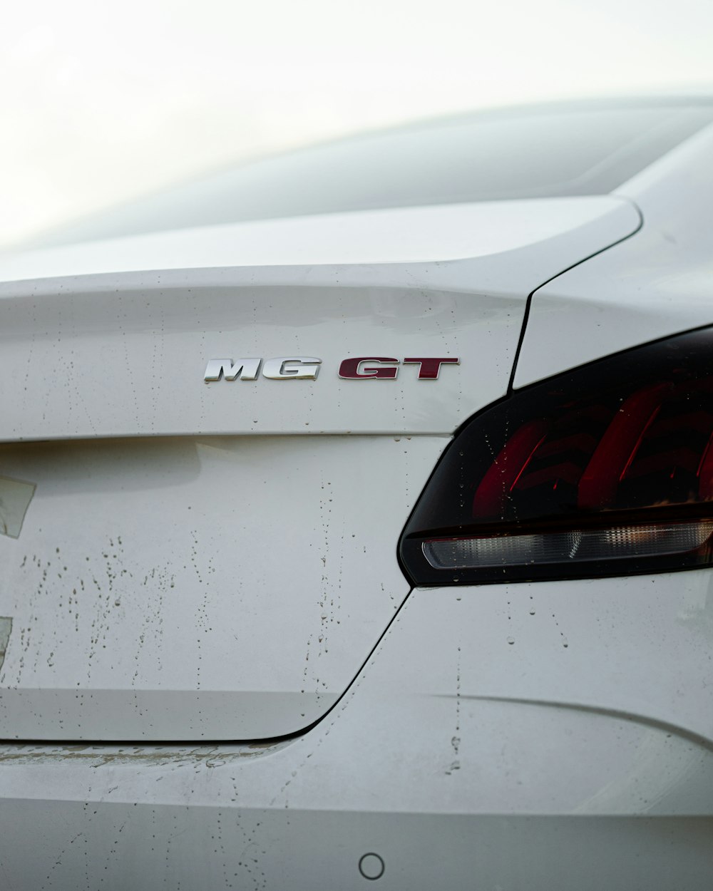 a close up of the tail end of a white car