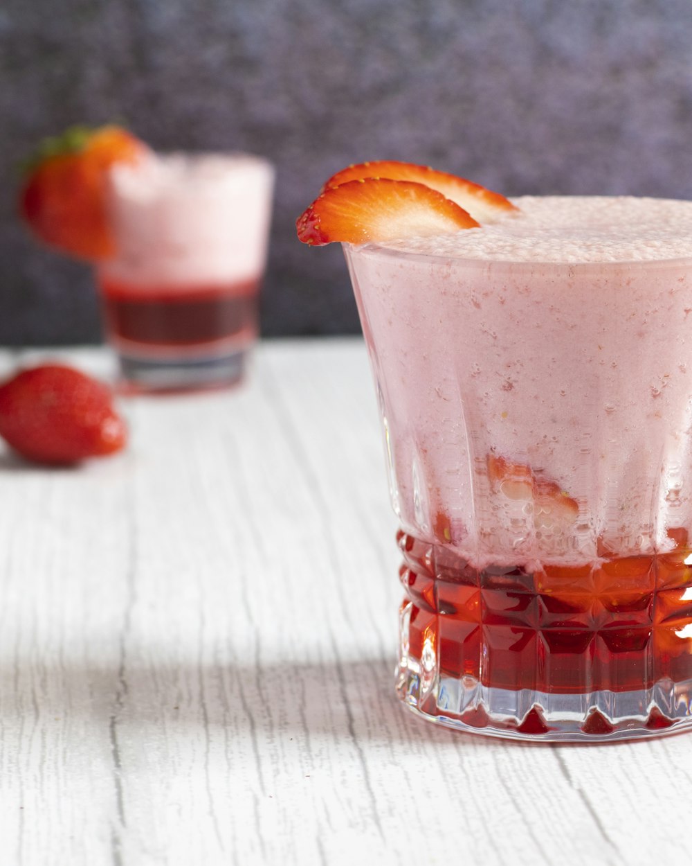 a drink with a slice of strawberry on top of it
