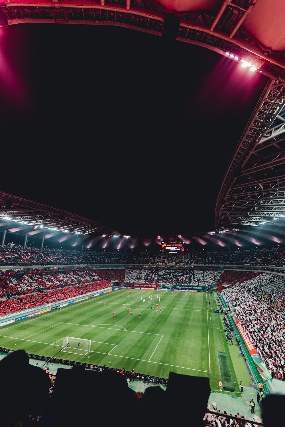 a stadium filled with lots of people watching a soccer game