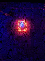 Four stylized beatnik cartoon cats logo illuminated on a DJ booth backdrop.