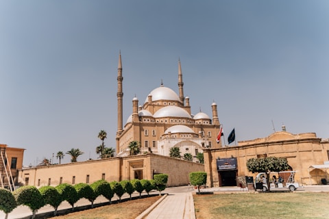 a large brown building with a white dome