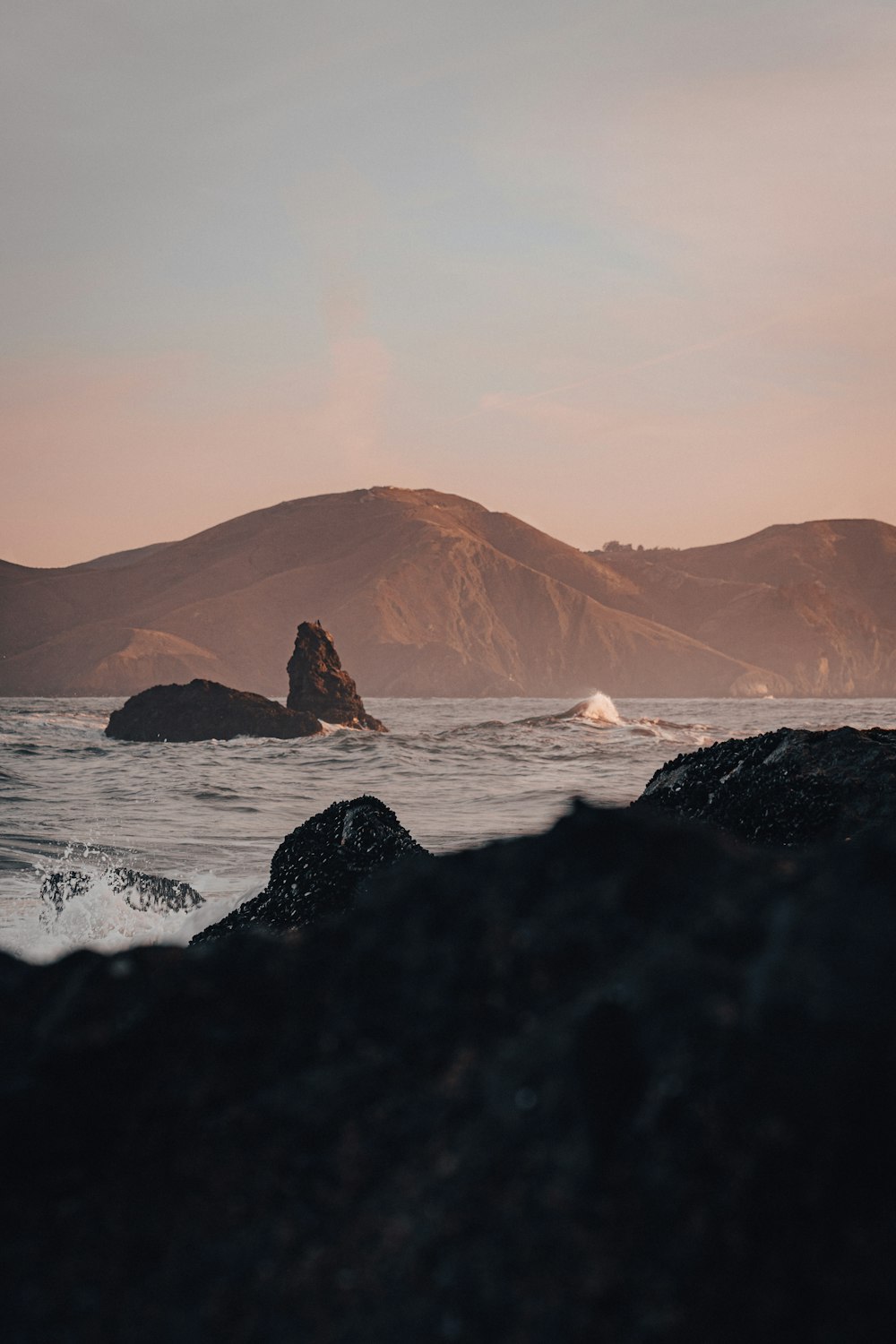 a body of water with mountains in the background