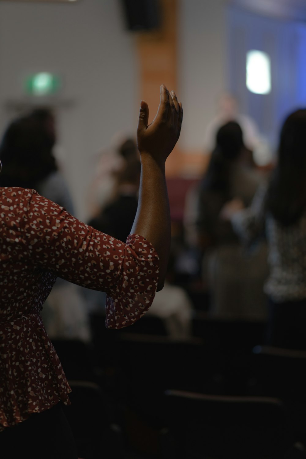 a woman standing in front of a crowd of people