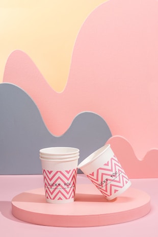 two cups of coffee sitting on top of a table