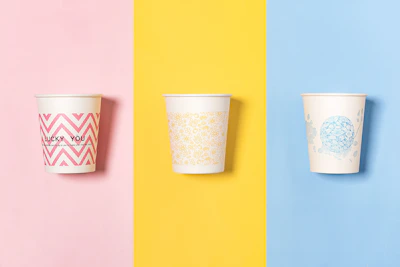 three different colored cups with designs on them