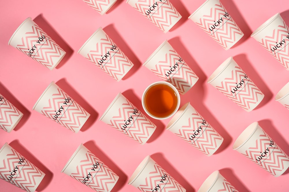 a cup of tea sitting on top of a pink table