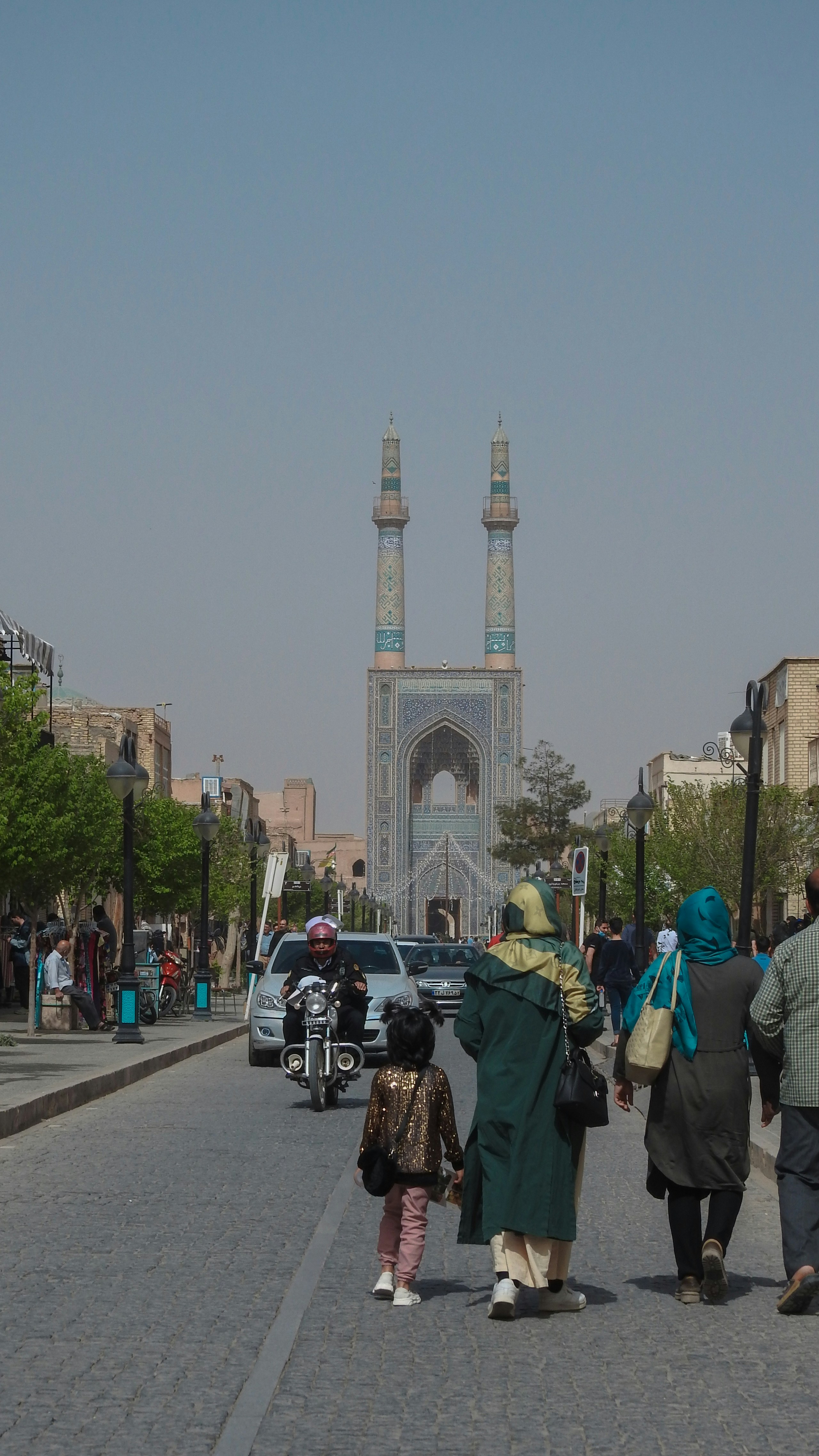 a group of people walking down a street